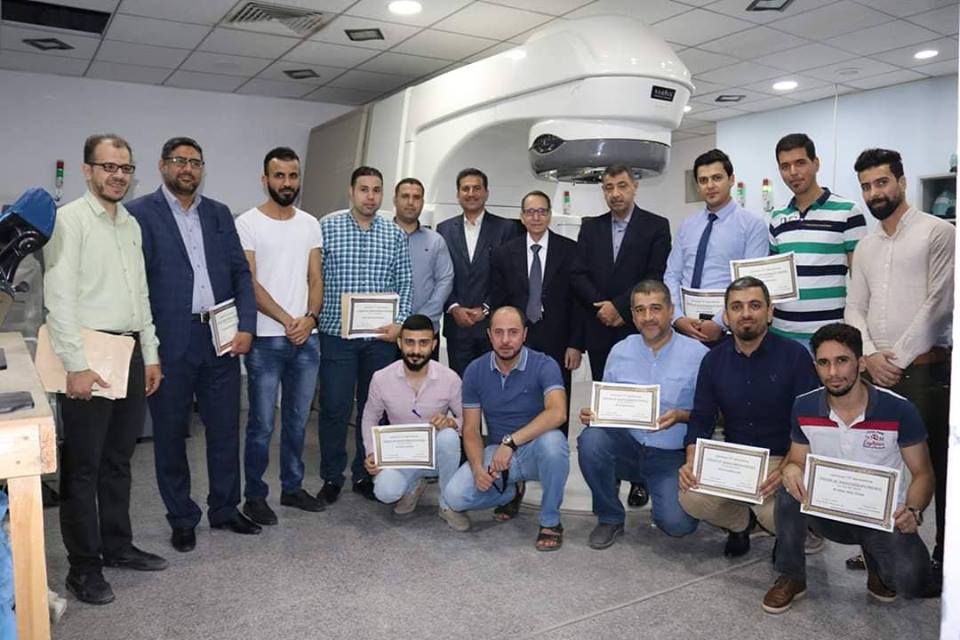 Figure 4: In the linac room, some of the attendees showing their certificates.